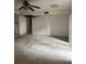 Living room needing repair featuring a ceiling fan and natural light from a window, open for renovation at 809 Camelot Dr # 809, College Park, GA 30349