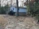 View of home's side showing a driveway, an attached one-car garage, and a two-story design at 905 Nw Magna Carta Dr, Atlanta, GA 30318