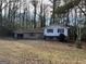Charming split-level home with a large front yard and a one car garage in a private, wooded setting at 905 Nw Magna Carta Dr, Atlanta, GA 30318
