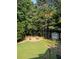 An aerial view of a backyard featuring a fire pit, shed, and green lawn at 1655 Peachcrest Dr, Lawrenceville, GA 30043