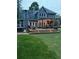 A backyard featuring a large deck with outdoor seating, a pergola, and a hot tub at 1655 Peachcrest Dr, Lawrenceville, GA 30043