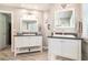 This bright bathroom includes two separate vanities with granite countertops and modern lighting above each mirror at 1655 Peachcrest Dr, Lawrenceville, GA 30043