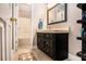 This bathroom features a dark wood vanity, modern tiling on the floor, and a bath and shower combo at 1655 Peachcrest Dr, Lawrenceville, GA 30043