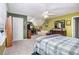 This secondary bedroom has a ceiling fan, natural light from the window, and unique architectural features at 1655 Peachcrest Dr, Lawrenceville, GA 30043