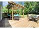 Spacious deck featuring a pergola, ample seating, and an outdoor grill perfect for entertaining at 1655 Peachcrest Dr, Lawrenceville, GA 30043