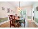 Elegant dining room featuring traditional wainscotting, a stylish light fixture and hardwood floors at 1655 Peachcrest Dr, Lawrenceville, GA 30043