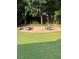 Backyard showing a brick fire pit surrounded by chairs at 1655 Peachcrest Dr, Lawrenceville, GA 30043