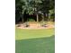 Backyard showing a brick fire pit surrounded by chairs at 1655 Peachcrest Dr, Lawrenceville, GA 30043