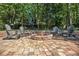 Inviting stone fire pit area with comfortable seating, set in a private wooded backyard retreat at 1655 Peachcrest Dr, Lawrenceville, GA 30043