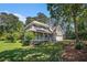 Charming two-story home featuring a welcoming front porch and lush, mature landscaping on a sunny day at 1655 Peachcrest Dr, Lawrenceville, GA 30043