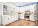 Kitchen featuring stainless steel appliances and white cabinets overlooking the living room at 1655 Peachcrest Dr, Lawrenceville, GA 30043