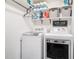 Practical laundry room equipped with modern washer, dryer, and storage shelves at 1655 Peachcrest Dr, Lawrenceville, GA 30043