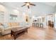 Open-concept living room with vaulted ceilings flows into a modern kitchen with bar seating and hardwood floors at 1655 Peachcrest Dr, Lawrenceville, GA 30043