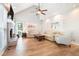 Spacious living room featuring a vaulted ceiling, fireplace, hardwood floors, and neutral decor at 1655 Peachcrest Dr, Lawrenceville, GA 30043