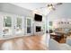 Sunlit living room featuring a fireplace, vaulted ceiling, hardwood flooring, and french doors at 1655 Peachcrest Dr, Lawrenceville, GA 30043