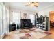 Well-lit home office featuring a ceiling fan, large window, and functional storage solutions for productivity at 1655 Peachcrest Dr, Lawrenceville, GA 30043