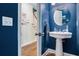 Stylish powder room features a pedestal sink and hardwood floors at 1655 Peachcrest Dr, Lawrenceville, GA 30043