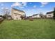 Expansive backyard with green lawn and a view of the home's exterior at 5686 Grindstone Dr, Buford, GA 30518