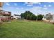 Large backyard with lush green grass and trampoline, perfect for activities at 5686 Grindstone Dr, Buford, GA 30518