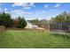 Sprawling backyard with lush green grass and a trampoline in the distance at 5686 Grindstone Dr, Buford, GA 30518