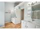 Bright bathroom features dual sinks with white cabinets and modern fixtures at 5686 Grindstone Dr, Buford, GA 30518
