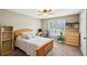 Cozy bedroom featuring a wooden bed frame, desk, and shelving unit at 5686 Grindstone Dr, Buford, GA 30518
