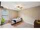 Simple bedroom with neutral tones, a single bed and a large window at 5686 Grindstone Dr, Buford, GA 30518