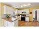 Well-equipped kitchen featuring white cabinetry, modern appliances, and ample counter space for cooking and entertaining at 5686 Grindstone Dr, Buford, GA 30518