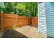 Fenced backyard with privacy fence, mature trees, and some space for gardening at 732 Jamestown Xing, Jonesboro, GA 30238