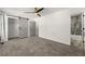 Bedroom featuring a modern ceiling fan, barn door closet, and renovated en suite bathroom at 732 Jamestown Xing, Jonesboro, GA 30238