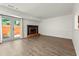 Open living room with ample space, fireplace, and sliding glass doors at 732 Jamestown Xing, Jonesboro, GA 30238