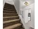Stairway featuring carpeted stairs and decorative overhead lighting leading to the kitchen at 732 Jamestown Xing, Jonesboro, GA 30238