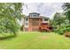Expansive backyard features a well-maintained lawn, multi-story home and a spacious deck at 805 Cog Hl, Mcdonough, GA 30253