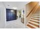 Basement featuring a staircase, large storage cabinet, tile flooring, and workout room, creating a spacious and functional area at 805 Cog Hl, Mcdonough, GA 30253
