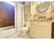 Classic bathroom featuring tiled floors, vanity with sink, bath and shower combination, and a decorative mirror at 805 Cog Hl, Mcdonough, GA 30253