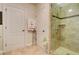 This bathroom features a tiled shower with a glass door, with towels, and a flower arrangement adding subtle touches at 805 Cog Hl, Mcdonough, GA 30253
