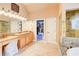 A spacious bathroom with dual vanities, soaking tub, and access to a walk in closet at 805 Cog Hl, Mcdonough, GA 30253