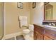 Well-lit bathroom includes a vanity, toilet, and framed art at 805 Cog Hl, Mcdonough, GA 30253