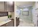 Bathroom featuring a stone sink, granite countertops, and a glass-enclosed shower, offering a spa-like experience at 805 Cog Hl, Mcdonough, GA 30253