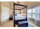 Bedroom features a four-poster bed, window, and ensuite bath at 805 Cog Hl, Mcdonough, GA 30253