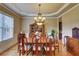 Formal dining room featuring a chandelier, an oval table, and beautiful hardwood floors at 805 Cog Hl, Mcdonough, GA 30253