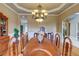 Elegant dining room with a large oval table, a chandelier, and classic wood accents at 805 Cog Hl, Mcdonough, GA 30253