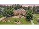 Stately brick home with a manicured lawn, mature trees, and elegant landscaping at 805 Cog Hl, Mcdonough, GA 30253