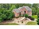 Elegant brick home boasts lush landscaping, a stone walkway, and decorative shrubbery at 805 Cog Hl, Mcdonough, GA 30253