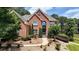 Charming brick home boasts manicured landscaping, a stone walkway, and decorative plantings at 805 Cog Hl, Mcdonough, GA 30253