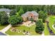 Beautiful brick home with lush lawn and landscaping featuring mature trees and colorful plants at 805 Cog Hl, Mcdonough, GA 30253