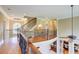 Hallway features hardwood floors, iron railing, and neutral paint at 805 Cog Hl, Mcdonough, GA 30253