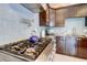Modern kitchen features a stainless steel range, sleek blue backsplash, and dark wood cabinetry at 805 Cog Hl, Mcdonough, GA 30253