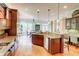 Open-concept kitchen with stainless steel appliances, granite countertops, and wooden cabinets at 805 Cog Hl, Mcdonough, GA 30253