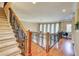 Upstairs landing with hardwood floors, iron railing, and a staircase at 805 Cog Hl, Mcdonough, GA 30253